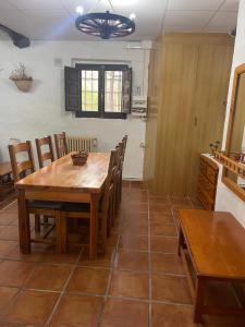 a kitchen and dining room with a wooden table and chairs at casa rural Mas Pare Sant in Alcoy
