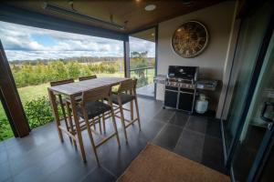 eine Küche mit Tisch und Stühlen und einem Herd in der Unterkunft Yuruga, Exeter in Exeter