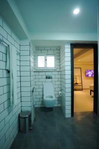 a bathroom with a toilet and a window at The Avenue Hotel in Islamabad