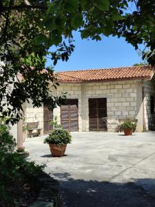 a building with two large pots in front of it at Country House UNA in Cupra Marittima