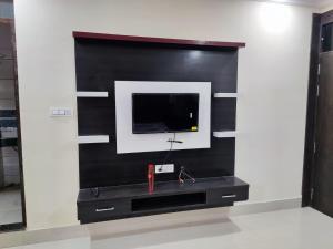 a wall mounted tv in a living room at Shubham guest house in Gwalior
