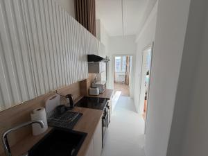 a kitchen with a sink and a stove top oven at Lumio in Košice