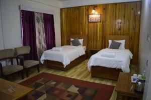 Ένα ή περισσότερα κρεβάτια σε δωμάτιο στο Hotel Elysium