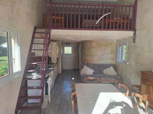 a room with a bunk bed and a table and a staircase at l'oasis in La Farlède