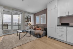 a living room with a couch and a table at Northstay - Cozy Arctic Apartment, Free Parking in Tromsø