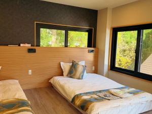 Ένα ή περισσότερα κρεβάτια σε δωμάτιο στο 苗場サンバレーホテル