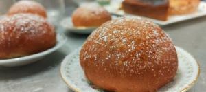 a bunch of donuts on plates on a table at Country House UNA in Cupra Marittima +26 photos