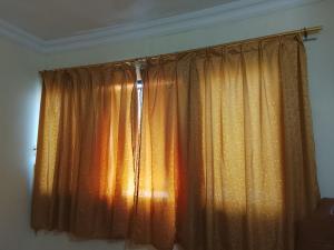 a window with orange curtains in a room at Alnan room's in Makkah