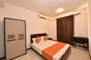 a bedroom with a bed and a desk in it at Villa Serein - Garden Suite in Galle