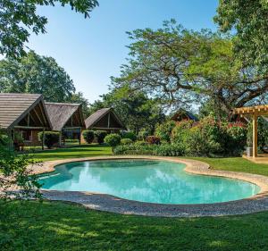 a swimming pool in the yard of a home at Hippo Hollow Country Estate in Hazyview