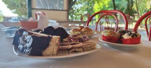 a plate of cake and cupcakes on a table at Country House UNA in Cupra Marittima
