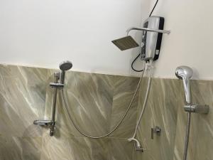 a shower in a bathroom with a blow dryer at Villa Safaya Hikkaduwa in Hikkaduwa +17 photos