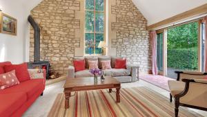 a living room with a couch and a table at The Stables, Batheaston in Batheaston