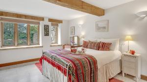 a bedroom with a bed and a window at The Stables, Batheaston in Batheaston
