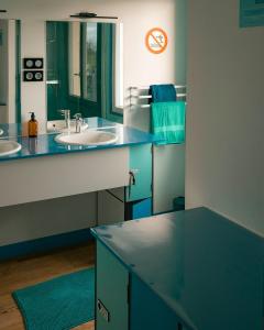 a bathroom with two sinks and a mirror at L'Escale du Cu de Loup in Quettehou +26 photos