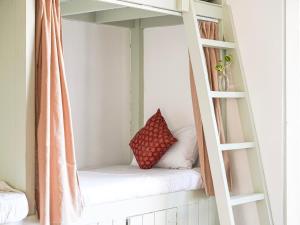 a room with a bunk bed with a pillow on it at Dorm Room in Boutique Wellness Hotel in Mirissa