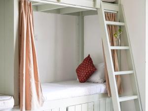a room with a bunk bed with a pillow on it at Dorm Room in Boutique Wellness Hotel in Mirissa +3 photos