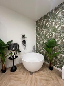 a bathroom with a large white tub and plants at affittacamerecoppola in Angri +22 photos