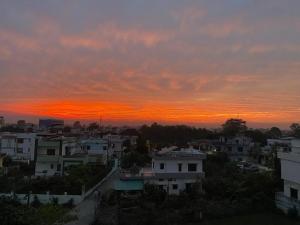 a view of a city at sunset at The Nest spacious and homely flat in Haldwani in Haldwāni