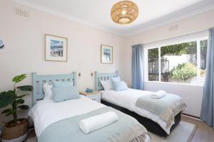 zwei Betten in einem Zimmer mit Fenster in der Unterkunft Beach Haven - steps from penguins w pool & views in Murdoch Valley + 28 Fotos