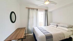 a bedroom with a large bed and a window at Villa Moya 46 in Margate