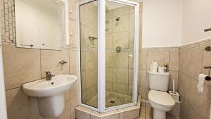 a bathroom with a shower and a toilet and a sink at Villa Moya 46 in Margate +7 photos