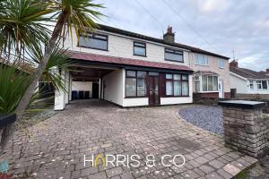 a house with a palm tree in front of it at Sandringham & Spa Villa in Thornton
