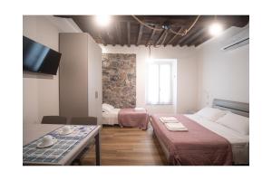 a small room with two beds and a table at Matt house in La Spezia