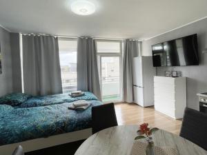 a bedroom with a bed and a table and a window at Work & Stay in Neuss in Neuss