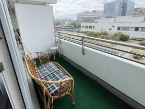 a chair sitting on a balcony with a view at Work & Stay in Neuss in Neuss
