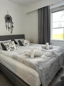 a large bed in a room with a window at Apartment Ahkiomaantie in Rovaniemi