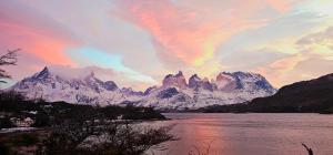 a mountain range with a rainbow in the sky at 6 personas - Casa amplia y acogedora en zona residencial in Puerto Natales +3 photos