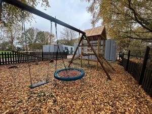 a playground with a swing set and a tower at 7 - Otters Halt - Dog friendly home & sleeps 6 in Sparham