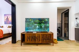 a living room with a large fish tank on a wooden cabinet at Westlands Nairobi, Marina Bay, 1 Bedroom Apartment, Swimming Pool, Gym, Workspace, JW Homes in Nairobi