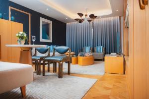 a room with a table and chairs and a living room at The Park New Delhi in New Delhi