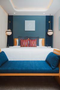 a bedroom with a large bed with blue walls at The Park New Delhi in New Delhi