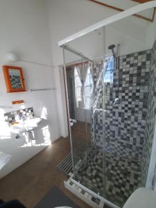 a bathroom with a shower and a sink at Vellies Getaway in Buffelspoort +20 photos