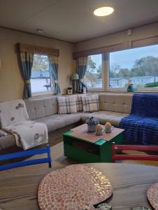 a living room with a couch and a table at Seton Sands Holiday Village GULLANE 5 in Longniddry