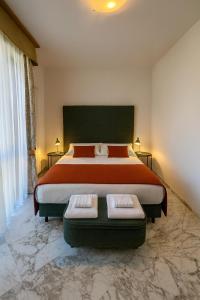 a large bedroom with a large bed with two seats at Antella Residence in Bagno a Ripoli
