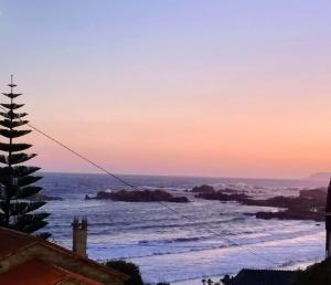 a view of the ocean at sunset at O Curro de Arou in Arou