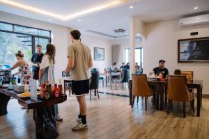 a group of people standing around in a restaurant at Jennie's Apartment in Cat Ba