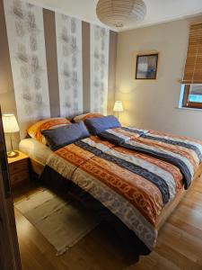 a bedroom with a large bed with blue pillows at Ferienwohnung Peetsch am See in Mirow