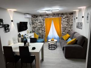 a living room with a couch and a table at El Boulevard de Trujillo 1997 in Trujillo