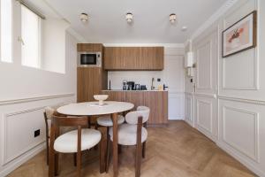 a kitchen with a table and chairs in a room at PoeticStay - Neuilly in Neuilly-sur-Seine +51 photos