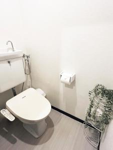 a white bathroom with a toilet and a plant at 久Hisashi 池下10号店 Nagoya in Nagoya +18 photos