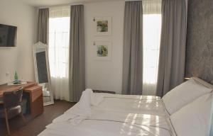 Postel nebo postele na pokoji v ubytování Vittoria Hotel-Restaurant