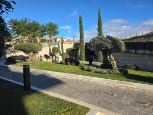 a path in a park with trees and a building at Alloggio turistico Dedicato in Gaeta