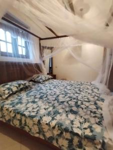 a bedroom with a bed with a comforter at Vista bella in Tangalle +62 photos