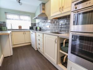 a kitchen with white cabinets and stainless steel appliances at The Lily Pad in Chester
