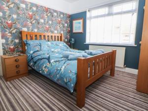 a bedroom with a bed with a blue comforter at The Lily Pad in Chester